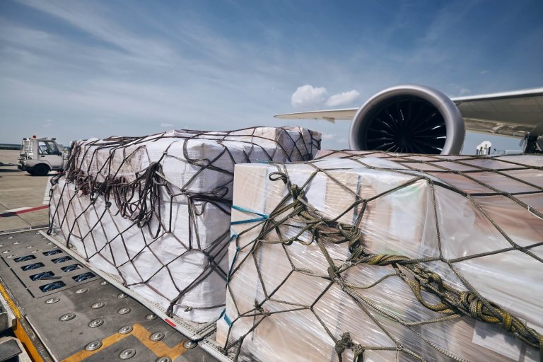 Cargo containers against jet engine of freight airplane