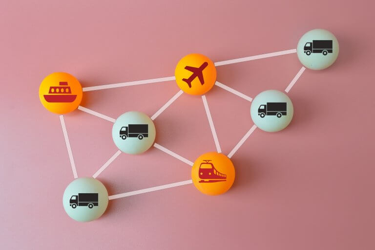 Connected logistics and supply chain concept. Table tennis ball with plane, trucks, train and ship s